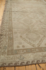 Distressed Oushak rug border with geometric motifs and subtle abrash in faded silver and bronze.