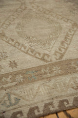 Vintage distressed Oushak rug detail: tone-on-tone geometric pattern with abrash in muted bronze.