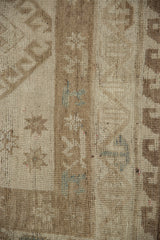 Muted bronze and silver abrash on distressed Oushak rug pile, highlighting worn knot heads.