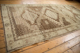 Vintage Oushak runner's bold serrated rectilinear medallions in brown and ivory hues.