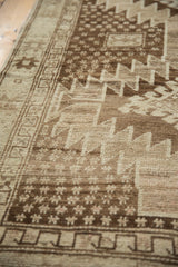 Vintage Oushak rug runner with serrated rectilinear border and dotted motifs in browns.