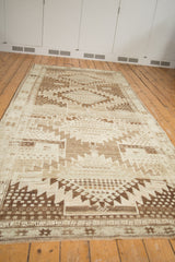 Vintage Oushak rug's serrated rectilinear patterns in brown, ivory, and subtle platinum shades.