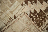 Vintage Oushak rug with hand-knotted back, secured side, and brown geometric pile.