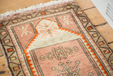 Plush soft blush pile and bright orange serrated geometric border of a vintage Oushak.