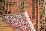 Vintage Oushak rug's tight reverse weave, red, grey, and orange geometric pattern with fringe.
