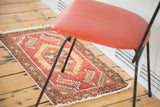 Blush rose vintage Oushak rug with hexagonal patterns and meandering palmette border.