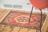 Blush rose Oushak rug with meandering leaf and palmette border detail.