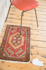 Vintage Oushak rug's blush rose field, lower corner, with meandering leaf and palmette border motif.
