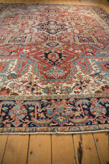 Ornate geometric Heriz pattern with energetic medallions in madder red, ivory, and blue.