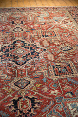 Vintage Heriz carpet detail: geometric navy, powder blue, and ivory motifs on a madder red field.