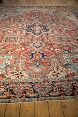 Vintage Heriz carpet's unusual Herati border with navy, red, and ivory fringe.