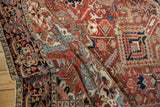 Vintage Heriz carpet's unusual herati border with navy, red, ivory geometric palmettes.