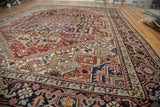Traditional vintage Heriz carpet corner with serrated stepped spandrel and navy border.