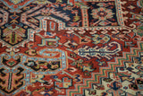 Serrated stepped spandrels of vintage Heriz carpet in brick red, navy, and aqua.