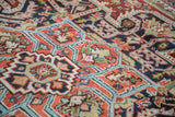 Vintage Heriz carpet's unique serrated stepped spandrels in brick red, navy, aqua.