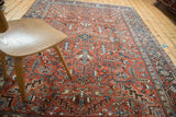 Classic geometric Heriz pattern featuring serrated leaves in terracotta, blue, and ivory tones.