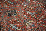 Textured pile of hand-knotted Heriz rug with burgundy, navy, and light blue motifs.