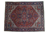 Vintage Heriz carpet with bold red field, navy center medallion, splayed geometric palmettes. 8'1