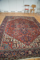Vintage Heriz rug with classic geometric medallion, splayed palmettes, rich red and navy.