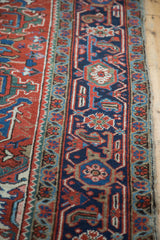 Geometric navy and red border of a vintage Heriz carpet with aqua accents.