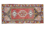 Vintage hand knotted Oushak rug, cherry red field with pinwheel medallion and geometric patterns.