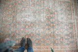 Distressed Oushak carpet with allover paisley-boteh design in cinnabar red and blanched teal.