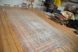 Distressed Oushak carpet with faded cinnabar red and blanched teal allover paisley design.