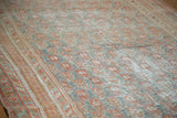 Decorative distressed Oushak rug detail: faded cinnabar, terra cotta, teal paisley pattern.