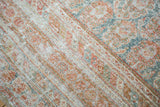 Allover distressed character with faded terra cotta and blanched teal motifs.