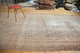 Faded cinnabar and blanched teal-green allover paisley design on a distressed Oushak carpet.
