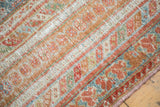 Distressed texture of a Turkish Oushak carpet, with cinnabar red and blanched teal paisley motifs.