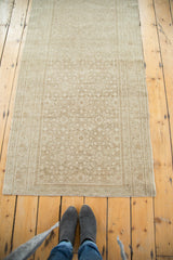 Long distressed Malayer runner with sand and beige tone-on-tone floral diamond motifs.