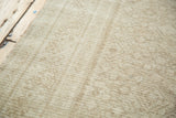 Distressed Malayer rug pile with intricate tone-on-tone sand, beige, and bronze pattern.