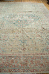 Distressed powder blue border and faded terracotta herati field patterns.