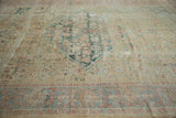Antique Sultanabad rug showing distressed field with muted mallard green and sky blue border detail.