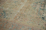 Distressed antique Sultanabad rug, worn beige field, mallard green Herati, and soft blue border.