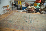 Distressed antique Sultanabad carpet displaying an allover Herati field with time-softened hues. 9x12.5.