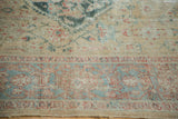 Distressed antique Sultanabad rug showing powder blue border with samovar design and herati field.