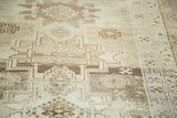 Vintage Oushak runner's geometric pattern, varied brown and ivory tones, soft green accents, and abrash.