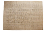 Distressed Oushak carpet with an allover blanched ivory beige field and charcoal floral vinery, 7'10