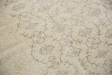 Tone-on-tone blanched ivory distressed Oushak carpet with charcoal floral vinery.