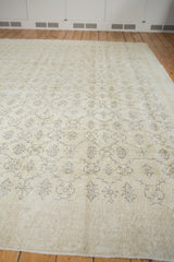 Simplistic charcoal floral vinery on blanched ivory distressed Oushak carpet.