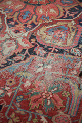 Worn pile of a distressed Ahar Heriz carpet, showcasing red, blue, and gold patterns.