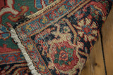 Distressed Ahar Heriz rug reverse, revealing knotting, tattered selvage, and multicolored fringe.