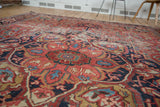 Decorative distressed texture of an Ahar Heriz rug, featuring red, blue, and gold patterns.