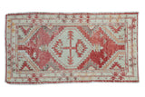 Distressed Turkish Oushak rug, faded cherry red geometric medallion and tribal motifs.