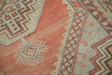 Distressed Oushak rug with faded cinnabar red, grey geometric stepped pattern, hooked motifs.