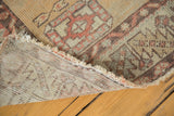 Detailed view of the hand-knotted foundation, original selvage, and distressed edge of an Oushak rug.