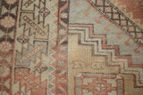 Stepped geometric patterns and distressed pile on a faded cinnabar Oushak rug.