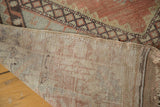 Hand-knotted foundation and distressed geometric pile texture of this vintage Oushak rug.